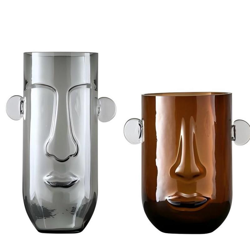 A human face has ears and holds a vase